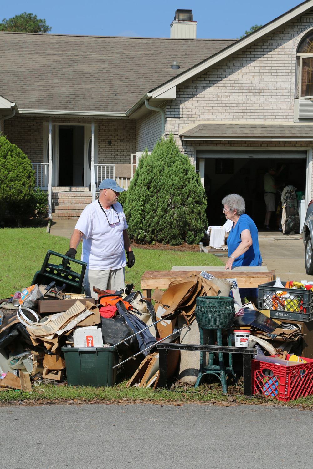 John Carrere, a member of the Knights of Columbus, volunteers Sept. 22 to help clean up after Hurricane Florence at the home of Nancy Sciara, a fellow parishioner at St. Paul Catholic Church in New Bern, North Carolina